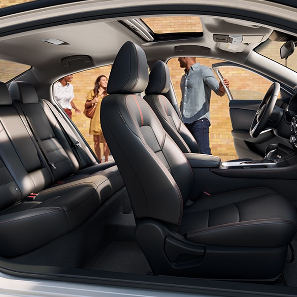 2024 Nissan Sentra seen from the passenger side, driver's side front and rear doors illustrating spacious interior.