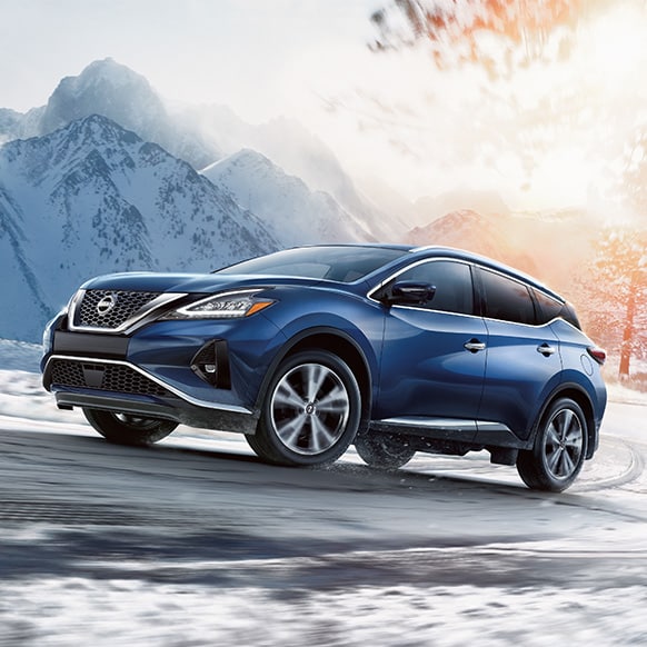 2024 Nissan Murano all-wheel-drive driving up a hill on a snowy road