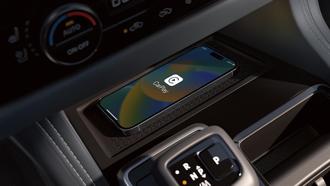 2024 Nissan Pathfinder detail view of interior showing iPhone displaying Apple CarPlay® logo.