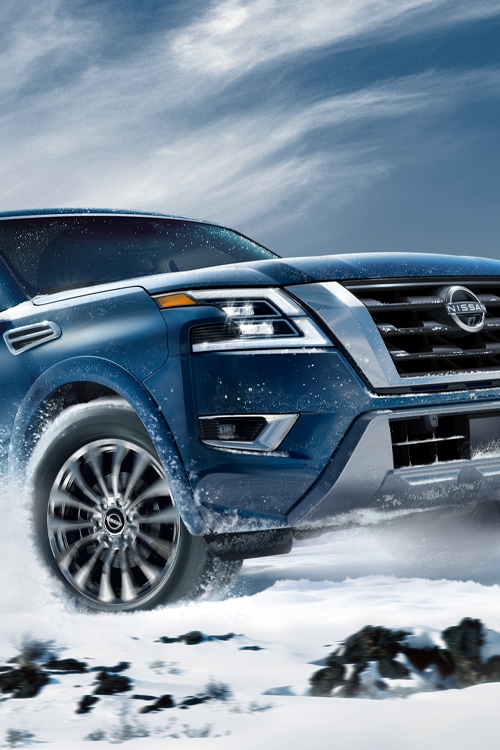 2024 Nissan Armada climbing a snowy hill to illustrate intelligent 4x4 capability