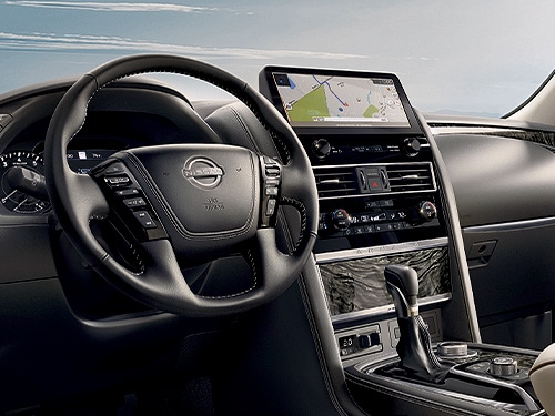 2024 Nissan Armada drivers view showing widescreen display, gauges, and steering wheel